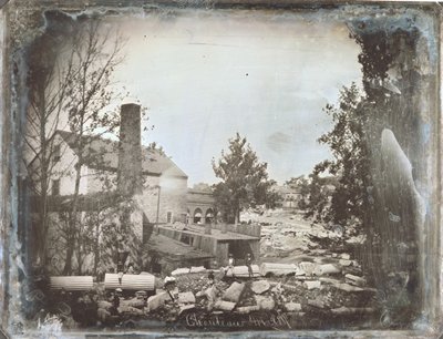 Men Seated on Rocks and What Appears to Be Architectural Columns by Thomas M. Easterly